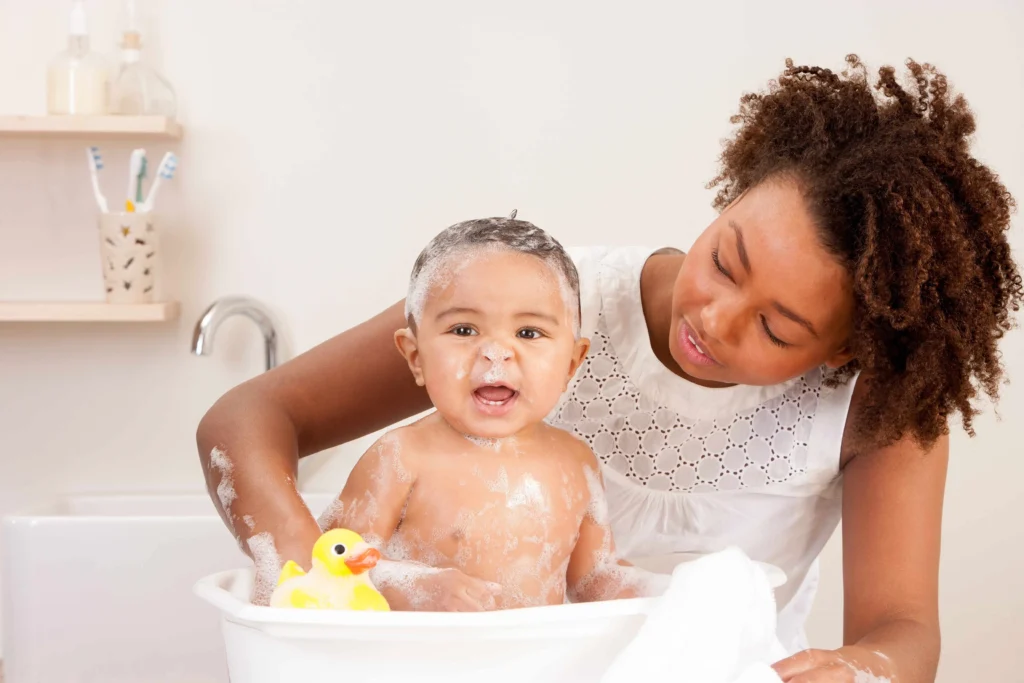 Parent gently washing a
baby's hair over the soft spot during bath time